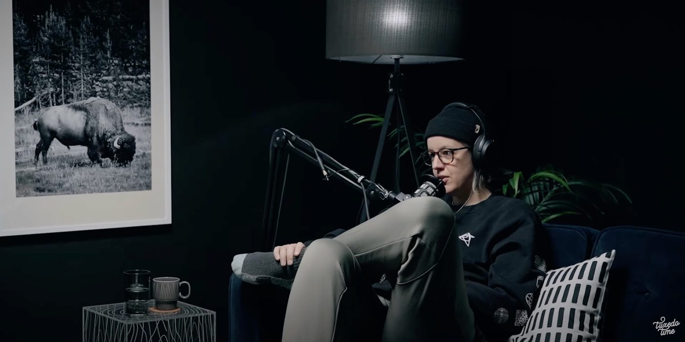 A host recording in a low-lit studio set