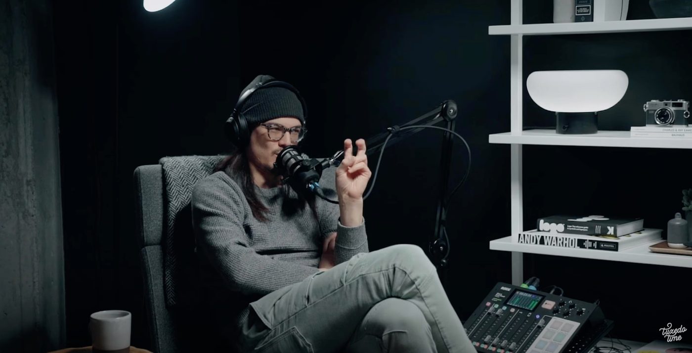 A host speaking into a boom-mounted microphone